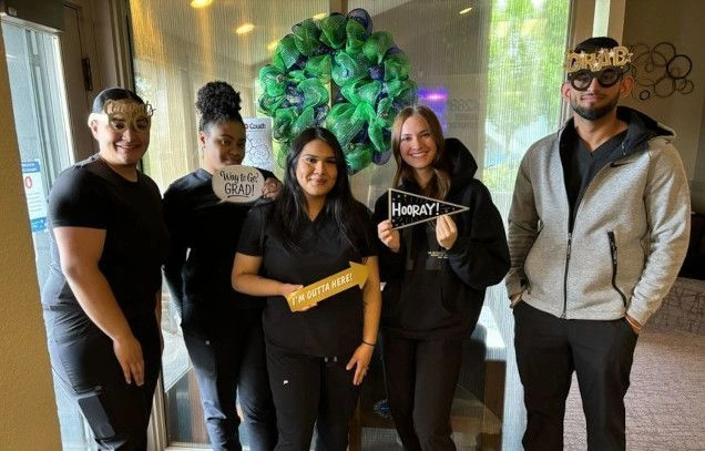 graduate students taking group photo after graduating